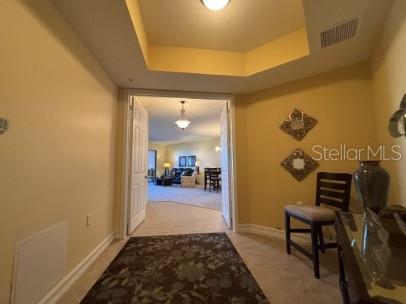 A foyer with tile flooring leads through double doors into a living and dining area — 8542 VIVANTE BOULEVARD, PUNTA GORDA, FL