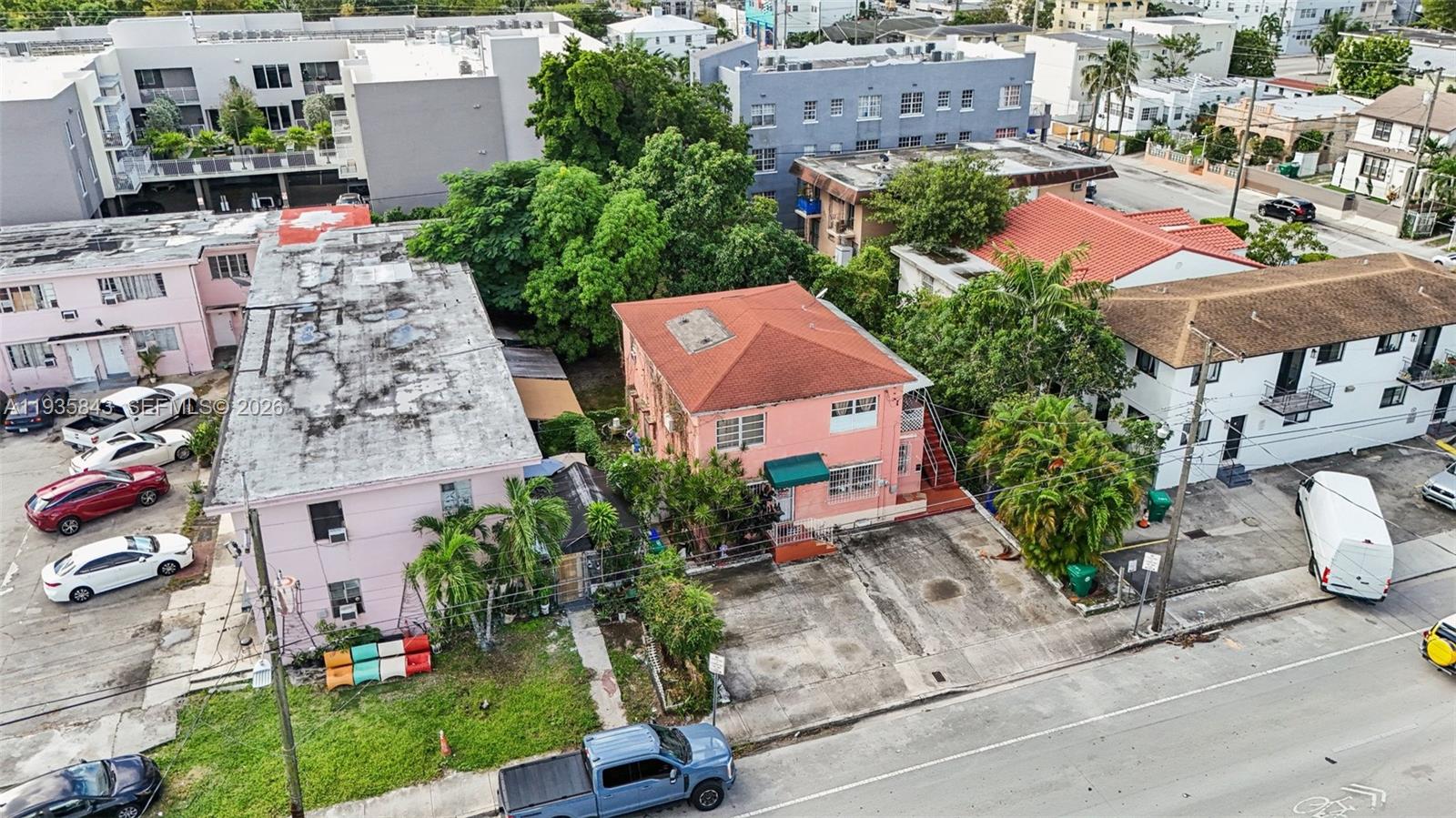 An aerial view shows a pink two-story building with a red roof and adjacent properties — 984 SW 6th St, Miami FL 33130, MIAMI, FL