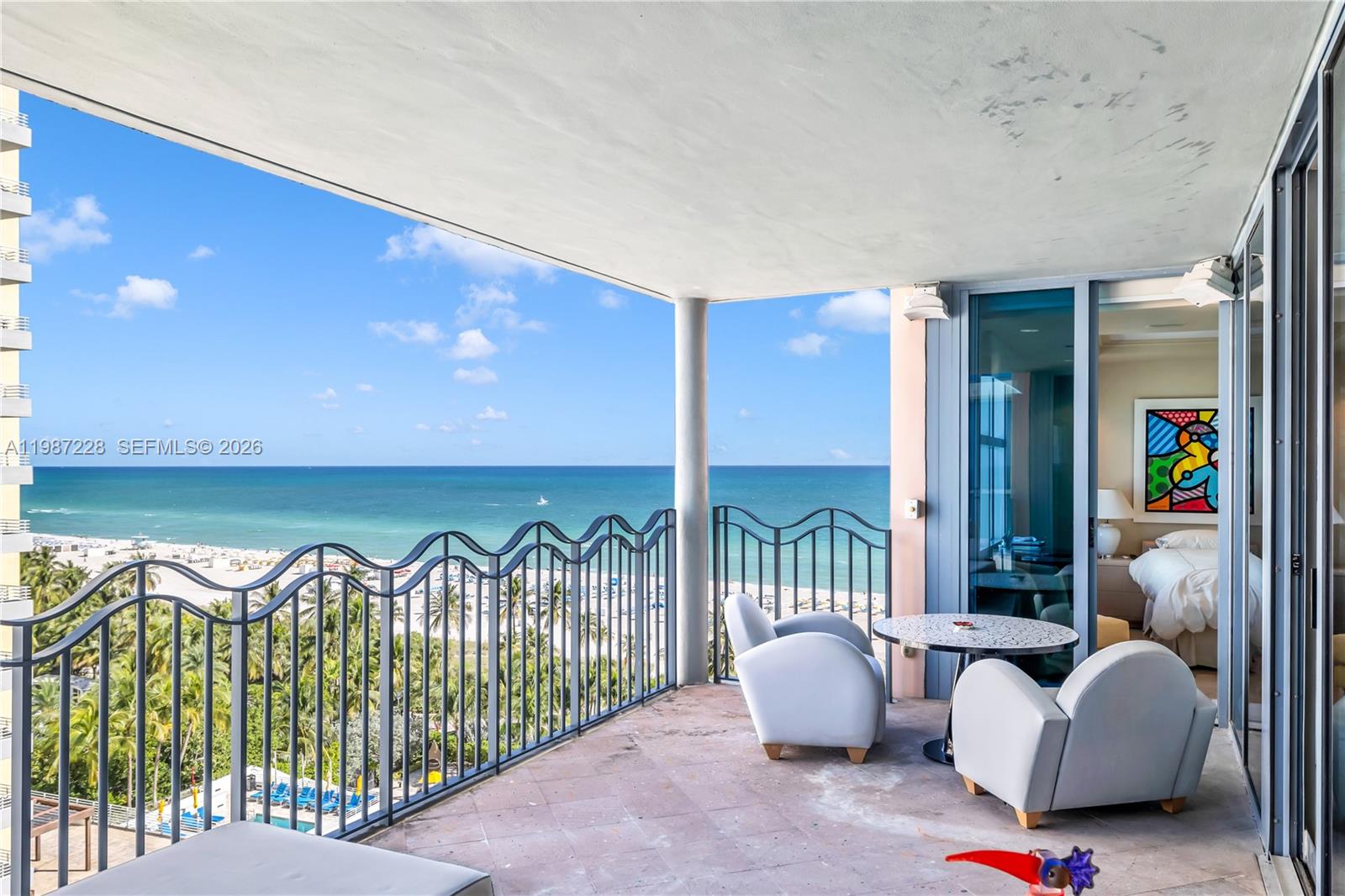A balcony with a metal railing overlooks the ocean and beach from a high-rise building — 1500 Ocean Dr # 1005, Miami Beach FL 33139, MIAMI BEACH, FL