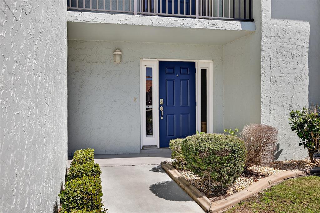 An aerial view shows a multi-story residential complex with a pool near a canal — 1461 AQUI ESTA DRIVE UNIT B3, PUNTA GORDA, FL