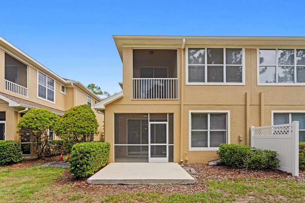 The exterior of a two-story townhouse features a screened-in patio and a concrete slab — 12639 SILVERDALE STREET, TAMPA, FL