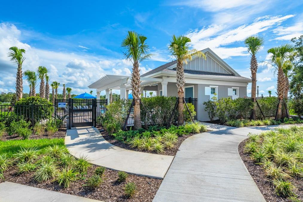 A concrete path leads to a pool house with a pergola and palm trees — 13654 TROPICAL BREEZE WAY, HUDSON, FL