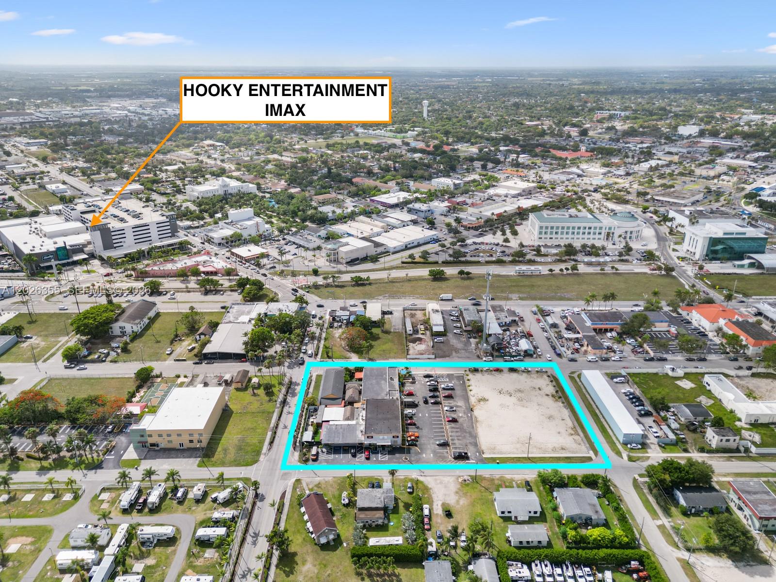 An aerial view shows a commercial property outlined in blue near a large entertainment complex — 17 NE 1st Rd, Homestead FL 33030, HOMESTEAD, FL