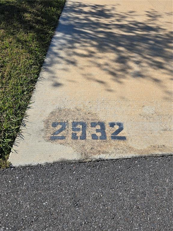 The house number 2932 is painted in black on the concrete driveway near the curb — 2932 NW 43RD COURT UNIT 421, OCALA, FL