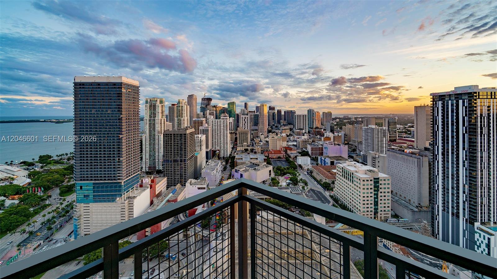 A high-angle view from a balcony overlooking the Miami skyline at sunset — 650 NE 2nd Ave # 1811, Miami FL 33132, MIAMI, FL