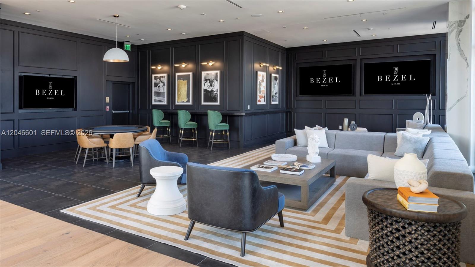 A modern lounge area features dark paneled walls, a large sectional sofa, and bar seating — 650 NE 2nd Ave # 1811, Miami FL 33132, MIAMI, FL