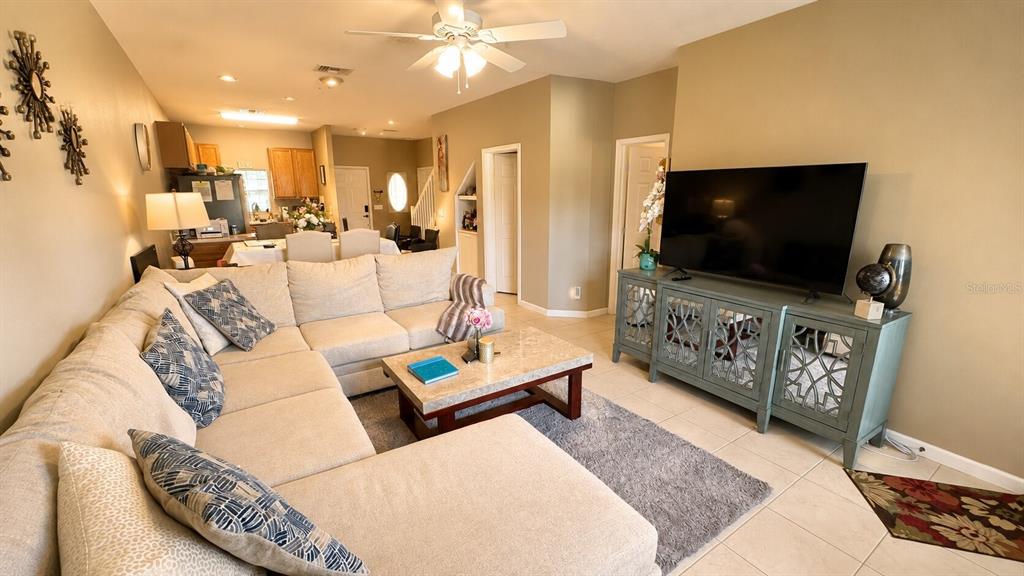 A living room features a large sectional sofa, a coffee table, and a television console — 1852 77TH DRIVE, VERO BEACH, FL