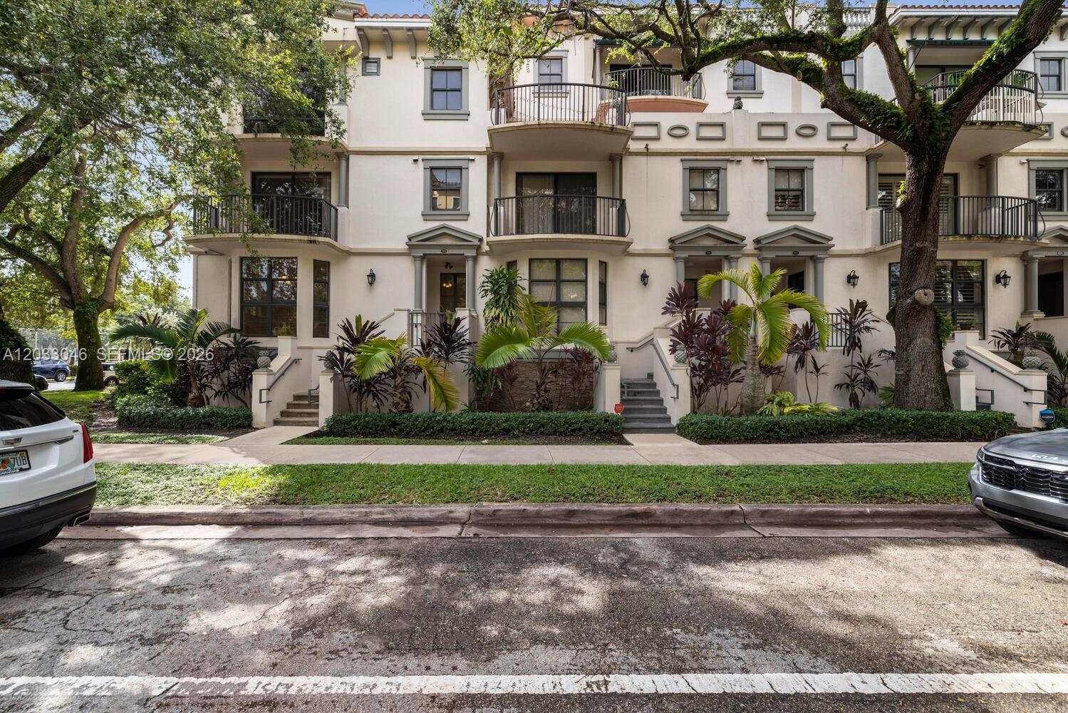 A multi-story residential building with balconies, stairs, and landscaping viewed from the street — 1650 Galiano St, Coral Gables FL 33134, CORAL GABLES, FL
