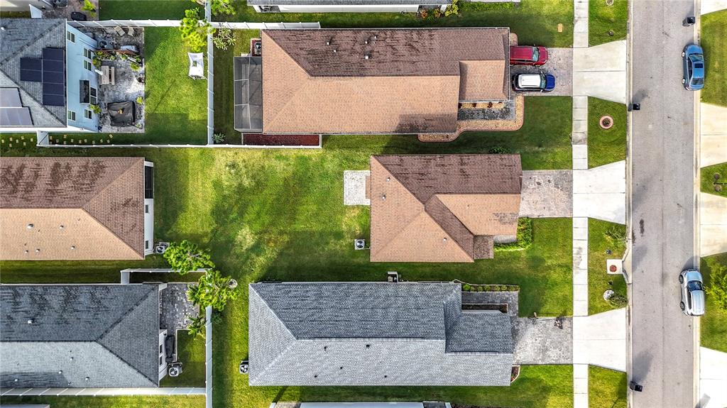 An aerial view shows several suburban houses with shingled roofs, driveways, and grassy backyards — 11829 CLARE HILL AVENUE, RIVERVIEW, FL