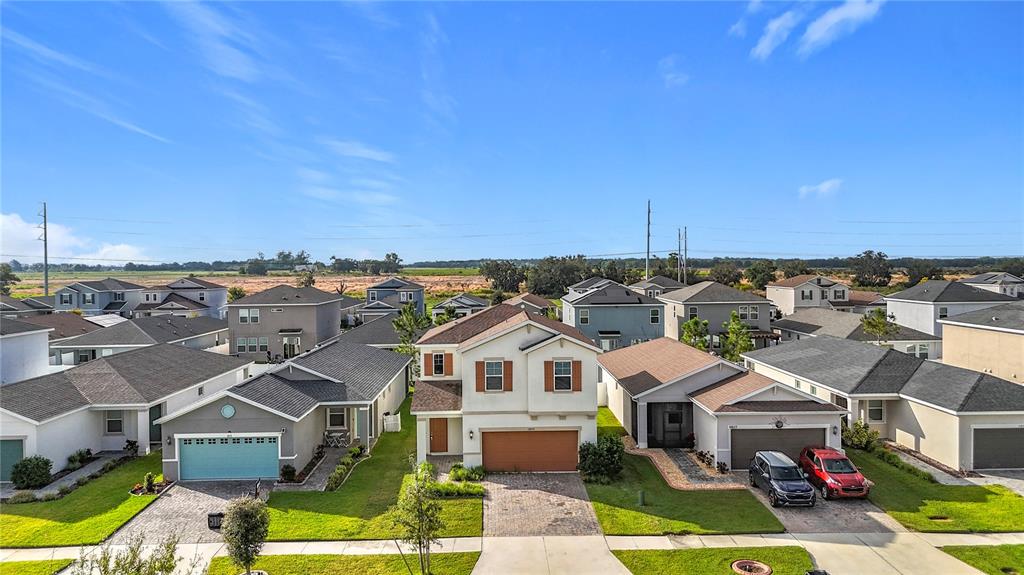 An aerial view shows a suburban neighborhood with multiple single-family homes and paved driveways — 11829 CLARE HILL AVENUE, RIVERVIEW, FL