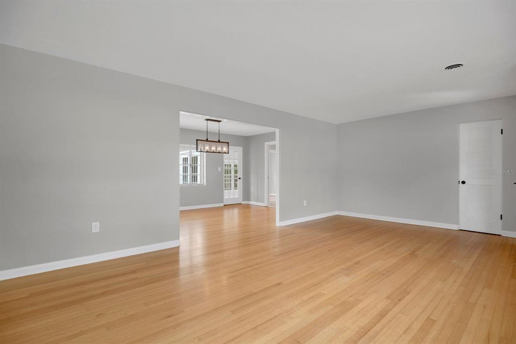An empty room with light gray walls, hardwood floors, and a doorway to another room — 1427 BRYN MAWR STREET, ORLANDO, FL
