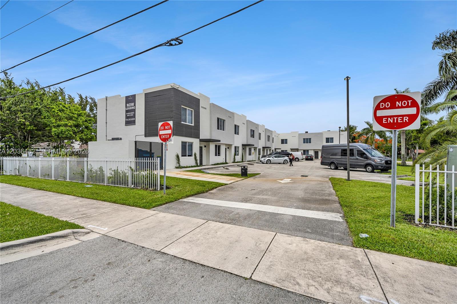 A modern multi-unit residential building features a concrete parking lot and two Do Not Enter signs — 170 NW 158th St # 2, Miami FL 33169, MIAMI, FL