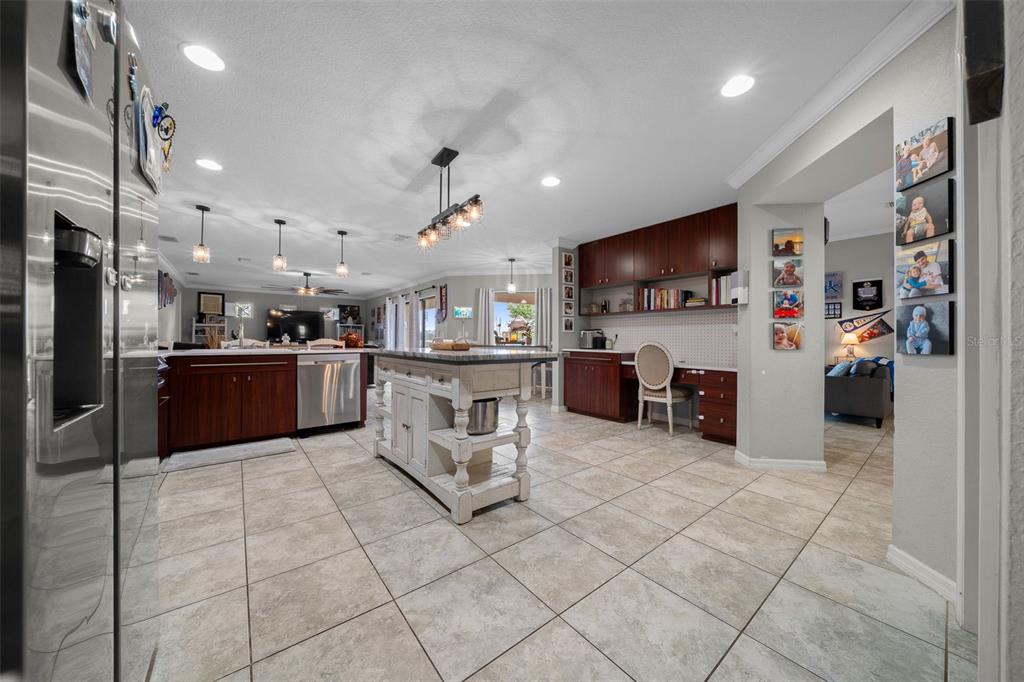 A living room features two gray sofas, a wooden coffee table, and tiled flooring — 6145 SE 96TH STREET, BELLEVIEW, FL
