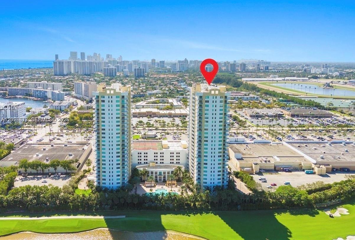 An aerial view shows two high-rise residential towers situated next to a golf course — 1745 E Hallandale Beach Blvd # 2104W, Hallandale Beach FL 33009, HALLANDALE BEACH, FL