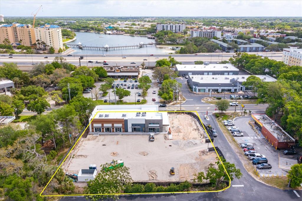 An aerial view shows a commercial building under construction on a large, cleared dirt lot — 286 DOUGLAS AVENUE, ALTAMONTE SPRINGS, FL