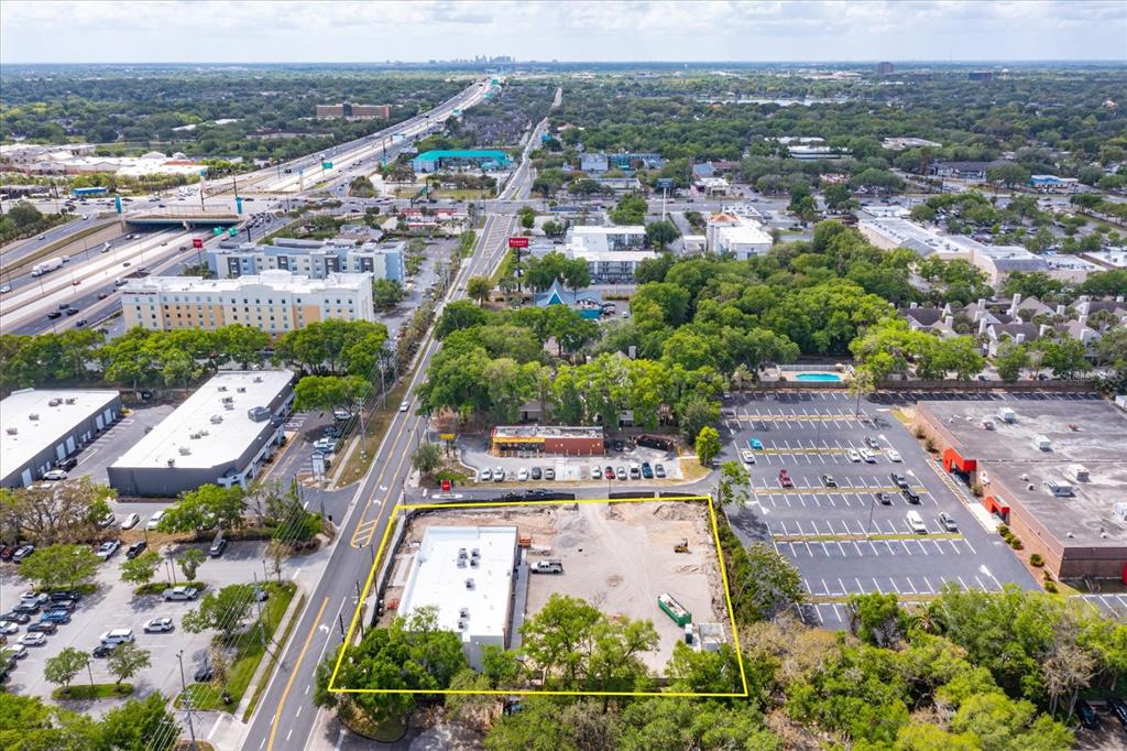 An aerial view shows a construction site with a building foundation and surrounding commercial properties — 286 DOUGLAS AVENUE, ALTAMONTE SPRINGS, FL
