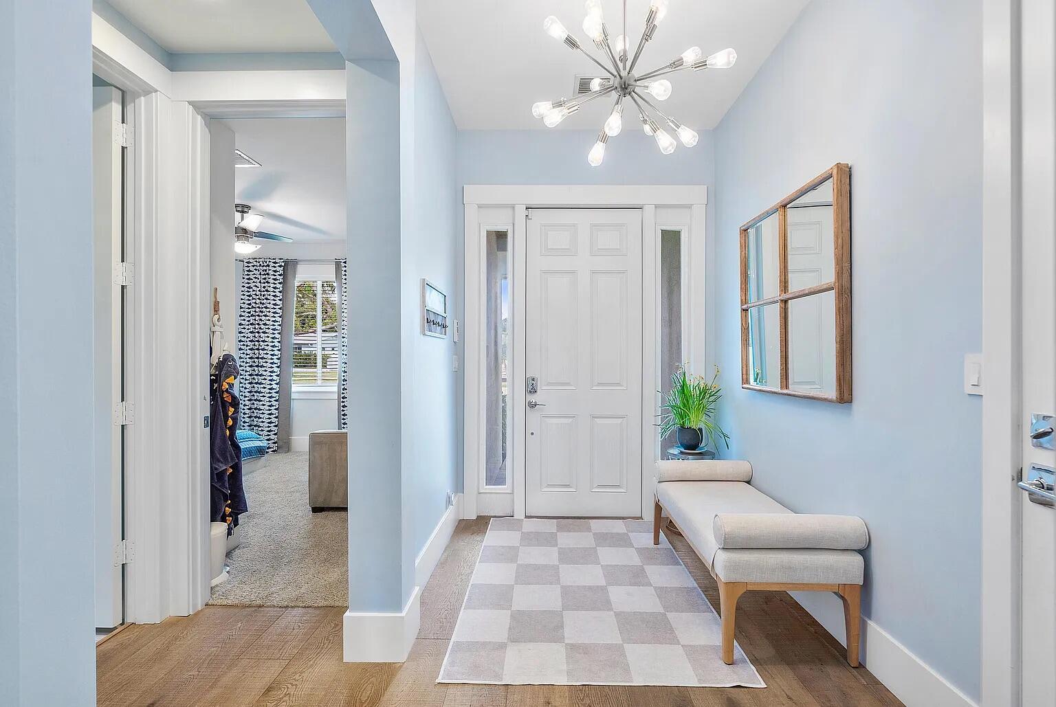 A light blue entryway features a white front door, a checkered rug, and a chandelier — 1420 High Ridge Road, FL 33461, FL