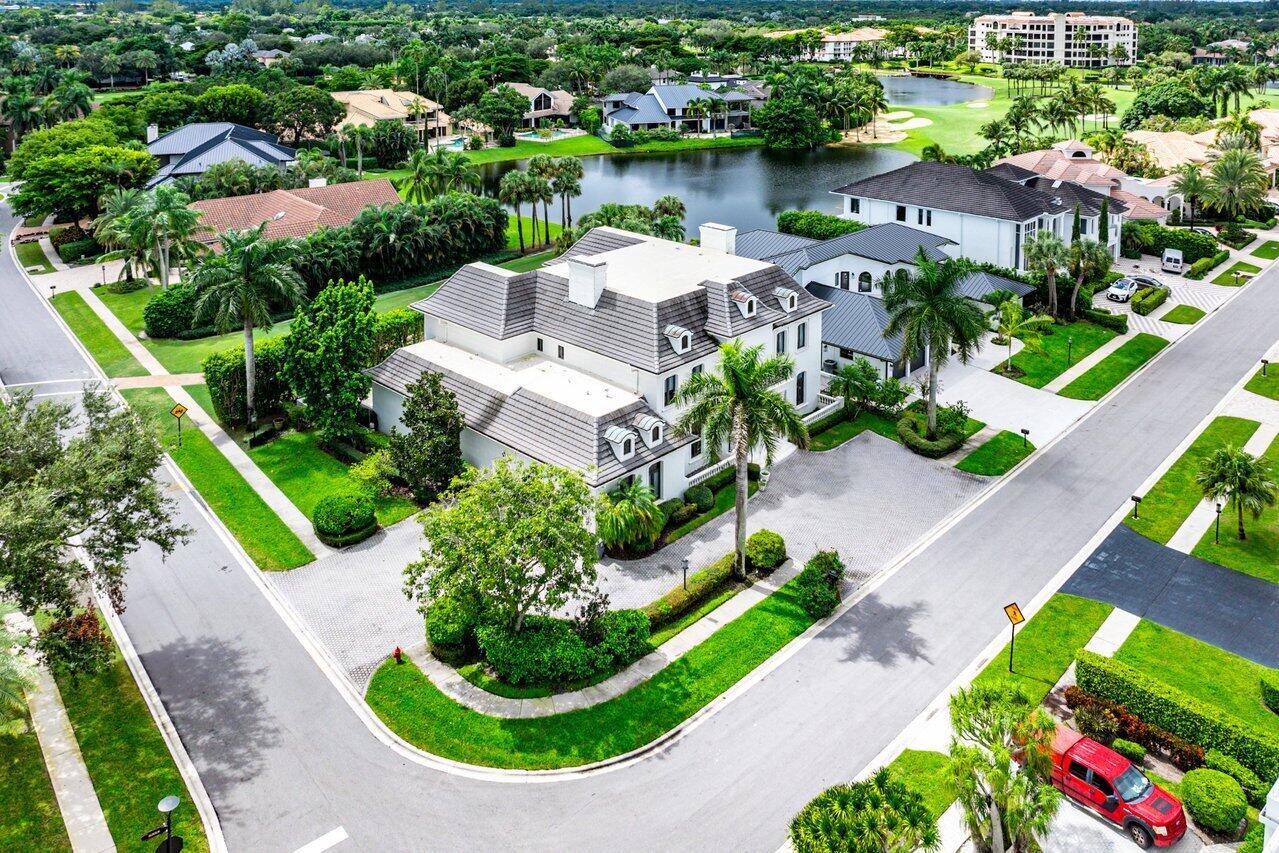 An aerial view shows a large, multi-story white house with a gray roof and palm trees — 7172 Valencia Drive, Boca Raton FL 33433, BOCA RATON, FL