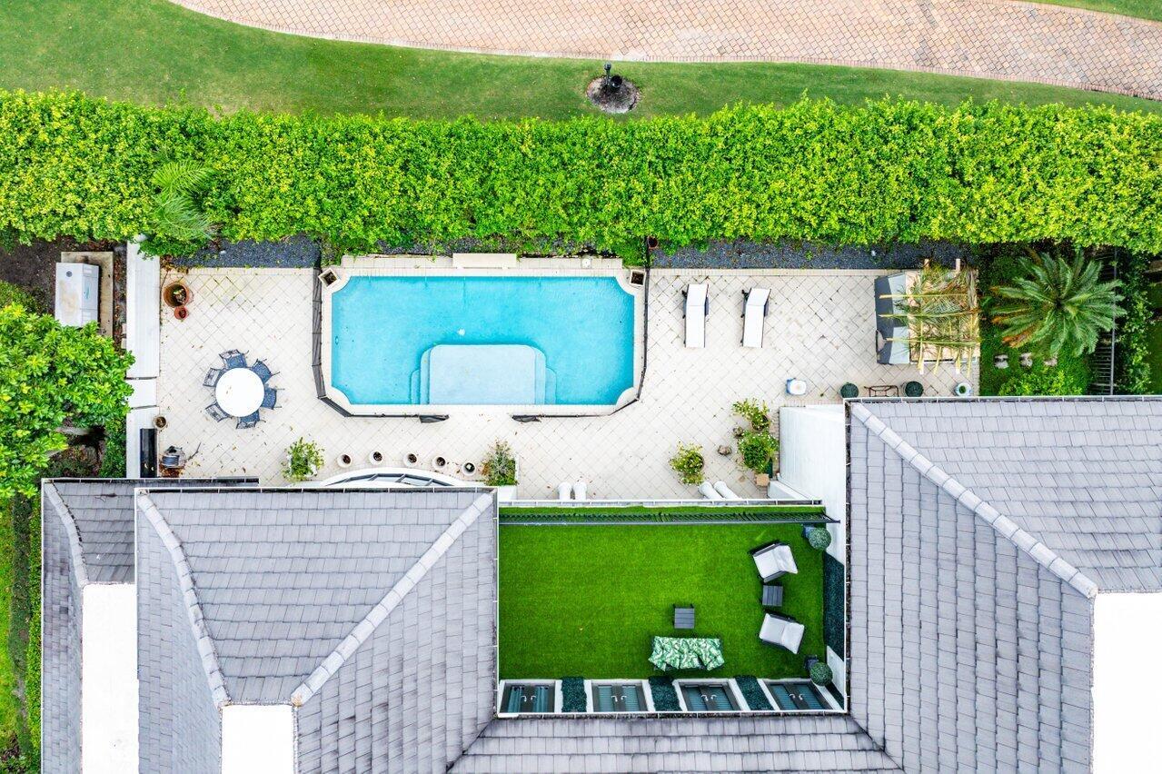 An aerial view shows a house with a rooftop terrace, swimming pool, and patio area — 7172 Valencia Drive, Boca Raton FL 33433, BOCA RATON, FL