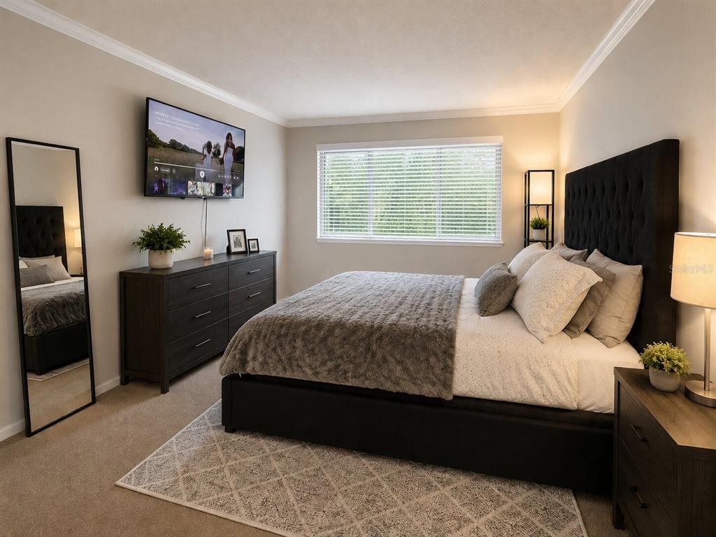 A bedroom features a dark upholstered bed, a dresser, a floor mirror, and a window — 1068 LOTUS PARKWAY UNIT 836, ALTAMONTE SPRINGS, FL