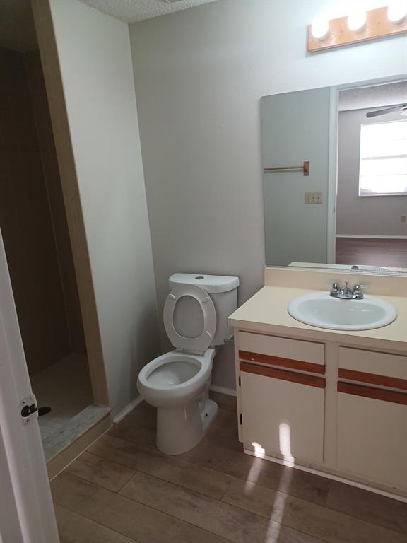 A bathroom features a vanity with a sink, a toilet, and a walk-in shower — 127 CAMPHOR CIRCLE UNIT D, OLDSMAR, FL