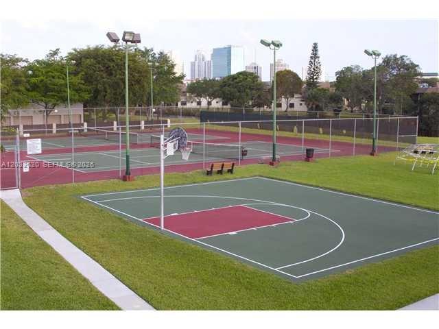 An outdoor basketball court and tennis courts are surrounded by a chain-link fence — 7956 Camino Cir # A4, Miami FL 33143, MIAMI, FL
