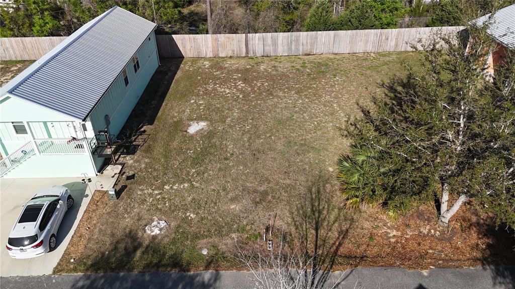 An aerial view shows a vacant residential lot situated between two houses — Lot 44 SW 879TH STREET, STEINHATCHEE, FL