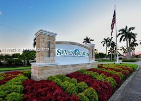 A stone monument sign for Seven Lakes stands in front of landscaped bushes and palm trees — OTHER CITY - IN THE STATE OF FLORIDA, FL