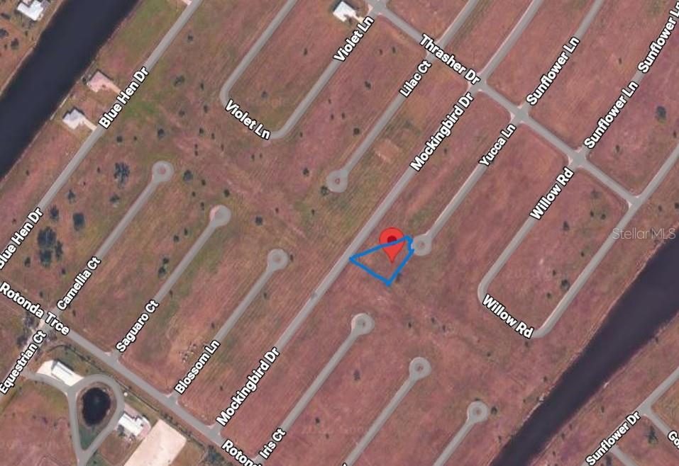 This is an aerial map view showing a vacant lot marked with a red pin — 1 YUCCA LANE, PLACIDA, FL