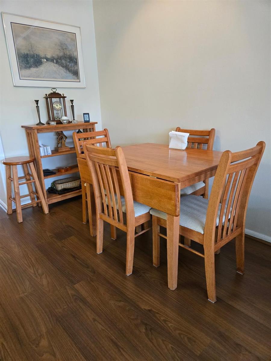A dining room features a wooden drop-leaf table with four chairs and a matching shelf — 111 Lyndhurst E # 111, Deerfield Beach FL 33442, DEERFIELD BEACH, FL