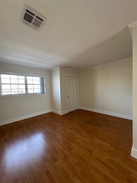 An empty room features light-colored walls, a window, and wood-look flooring — 12990 SW 63rd Ter # 605, Miami FL 33183, MIAMI, FL