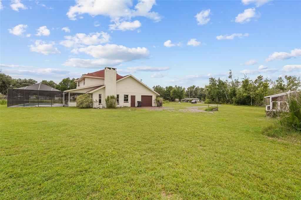A two-story house with a pool enclosure and a large grassy yard — 3101 LAKE LOWERY ROAD, HAINES CITY, FL