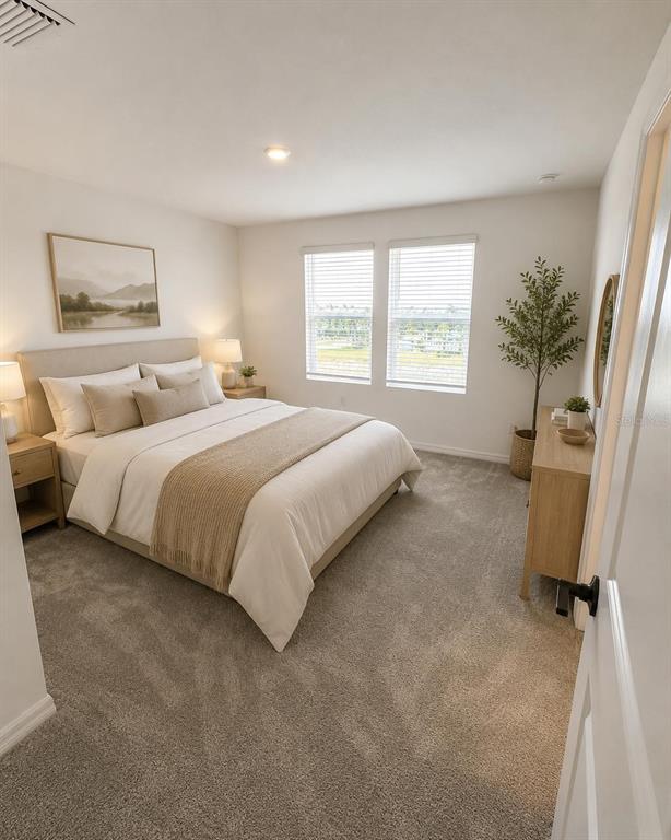 A bedroom features a queen bed, two nightstands, a dresser, and two windows with blinds — 8749 WINTER BREEZE WAY, SARASOTA, FL
