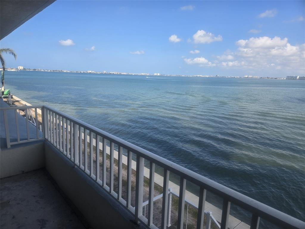 A balcony with a white metal railing overlooks a large body of water — 5153 ISLA KEY BOULEVARD S UNIT 215, ST PETERSBURG, FL