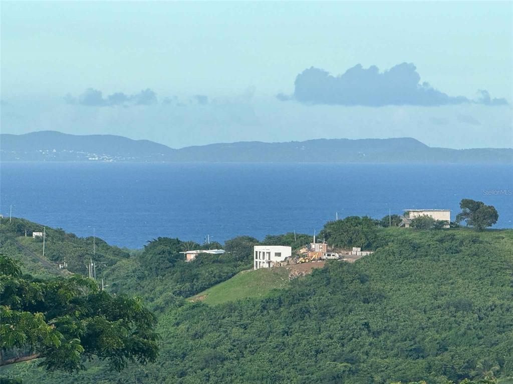 A view of a hillside landscape overlooking the ocean with a house under construction — 31 SAMUEL FELIX, VIEQUES, PR