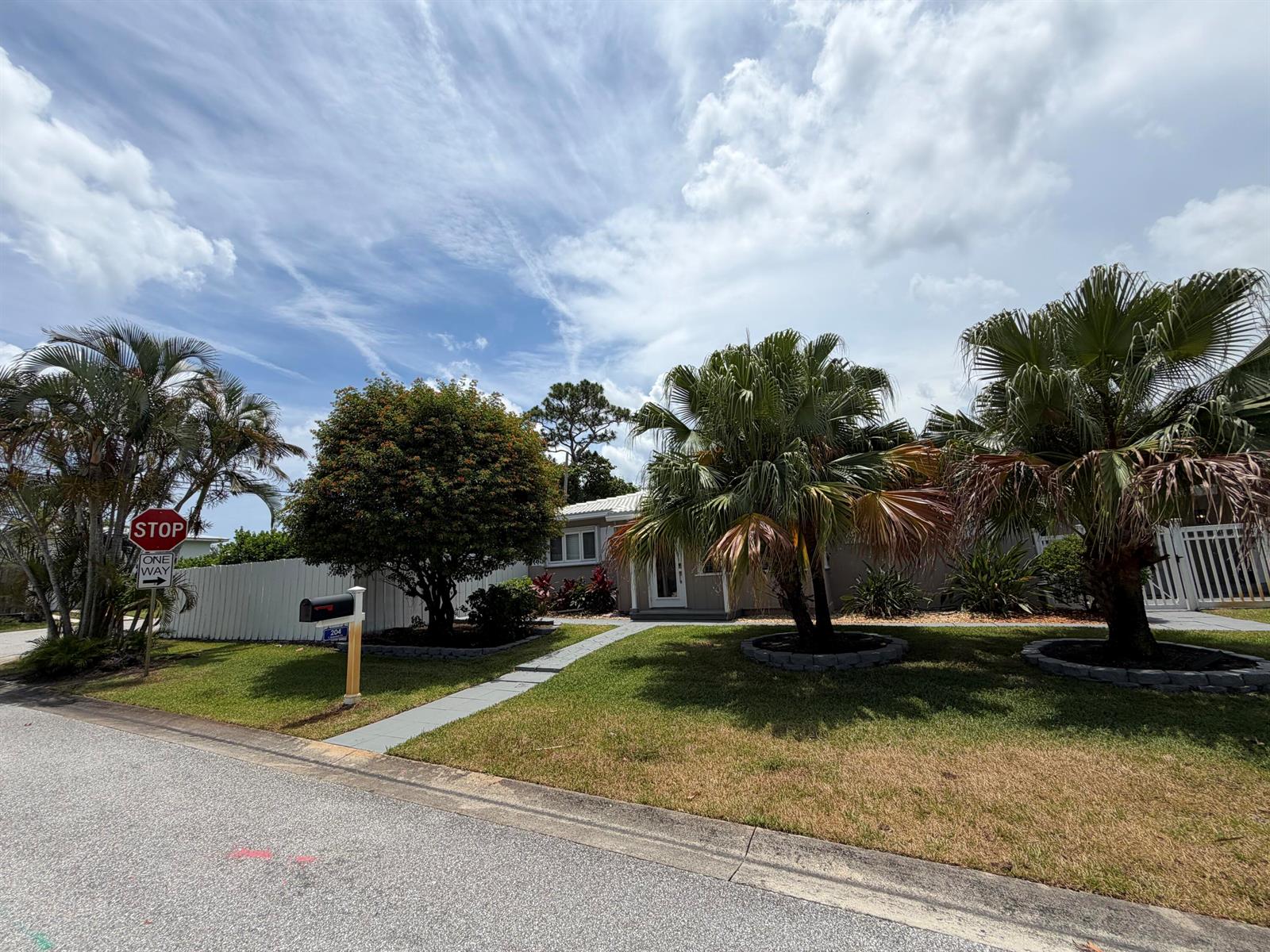 A single-story house with a front yard, palm trees, and a paved walkway — 204 S Seacrest Circle, Delray Beach FL 33444, DELRAY BEACH, FL