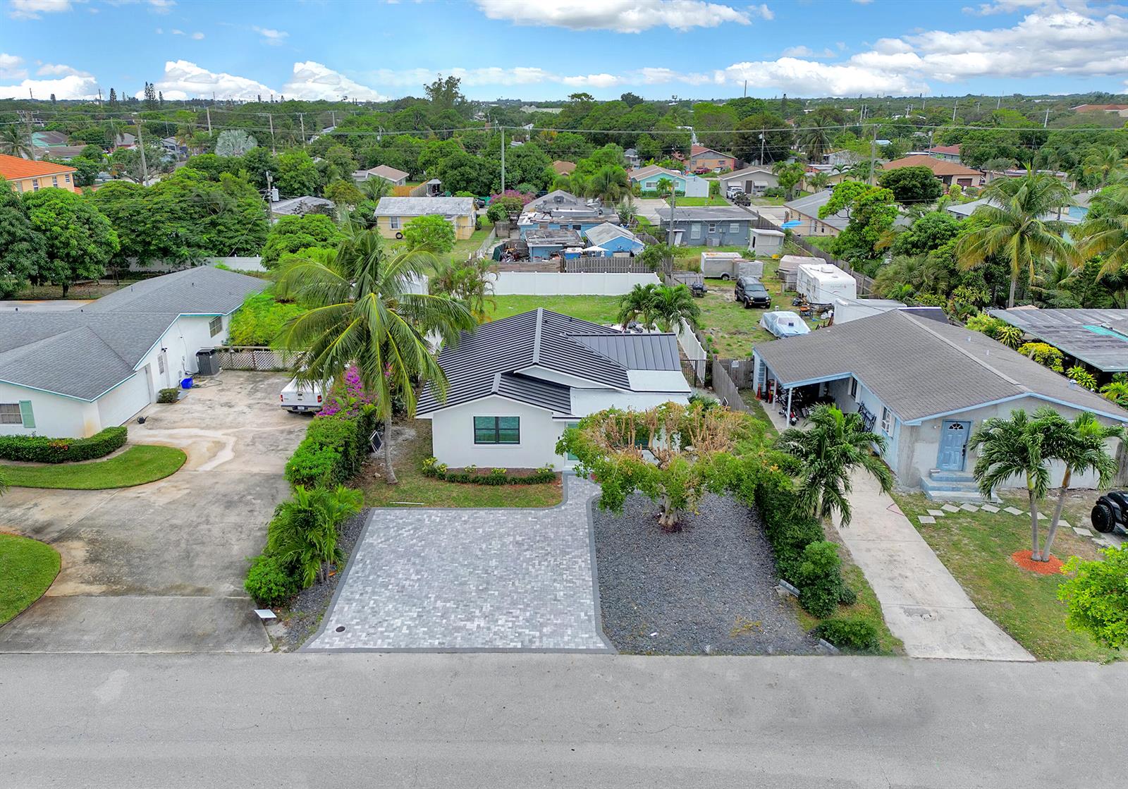 An aerial view shows a white house with a dark metal roof and paved driveway — 320 NW 3rd Avenue, Delray Beach FL 33444, DELRAY BEACH, FL