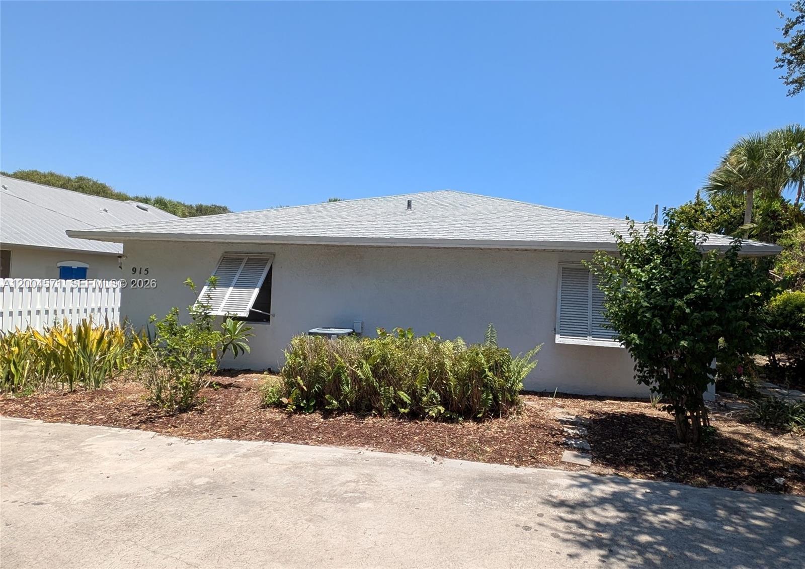 A single-story house with a light-colored exterior, a hip roof, and white shutters — 915 Turtle Cove Ln, Vero Beach FL 32963, VERO BEACH, FL