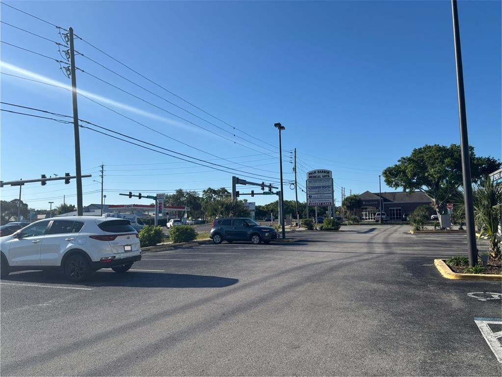 A parking lot in front of a medical arts building under a clear blue sky — 2855 ALT 19, PALM HARBOR, FL