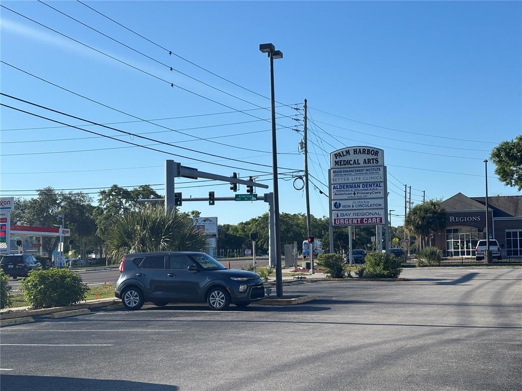 A gray car is parked in a lot near a Palm Harbor Medical Arts sign — 2855 ALT 19, PALM HARBOR, FL