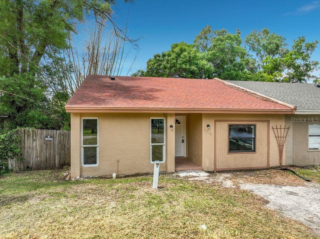 A single-story house with a tan stucco exterior, a red roof, and a front porch — 5214 2ND STREET, ORLANDO, FL