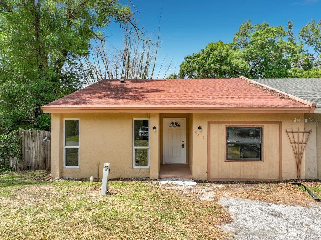 A single-story house with a tan stucco exterior, a red roof, and a front entrance — 5214 2ND STREET, ORLANDO, FL