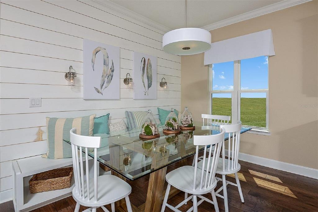 A dining room features a glass-top table, white spindle chairs, a built-in bench, and shiplap walls — 3547 CYNTHIA LANE, ORANGE PARK, FL