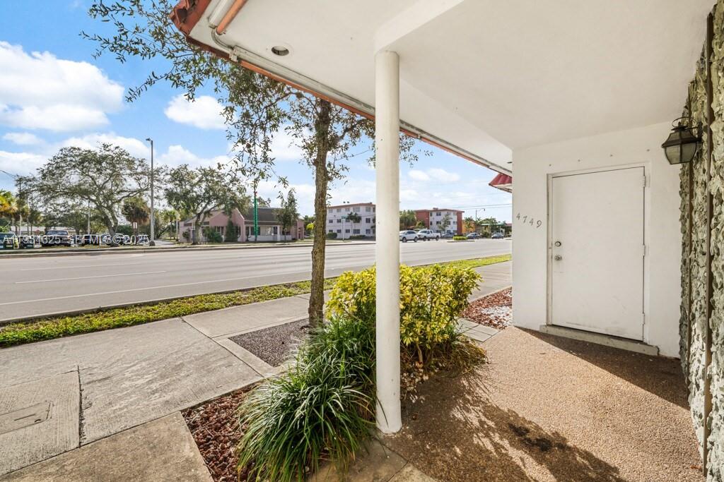 A white door with the number 4149 is located under a covered walkway near a street — 4749 Hollywood Blvd, Hollywood FL 33021, HOLLYWOOD, FL