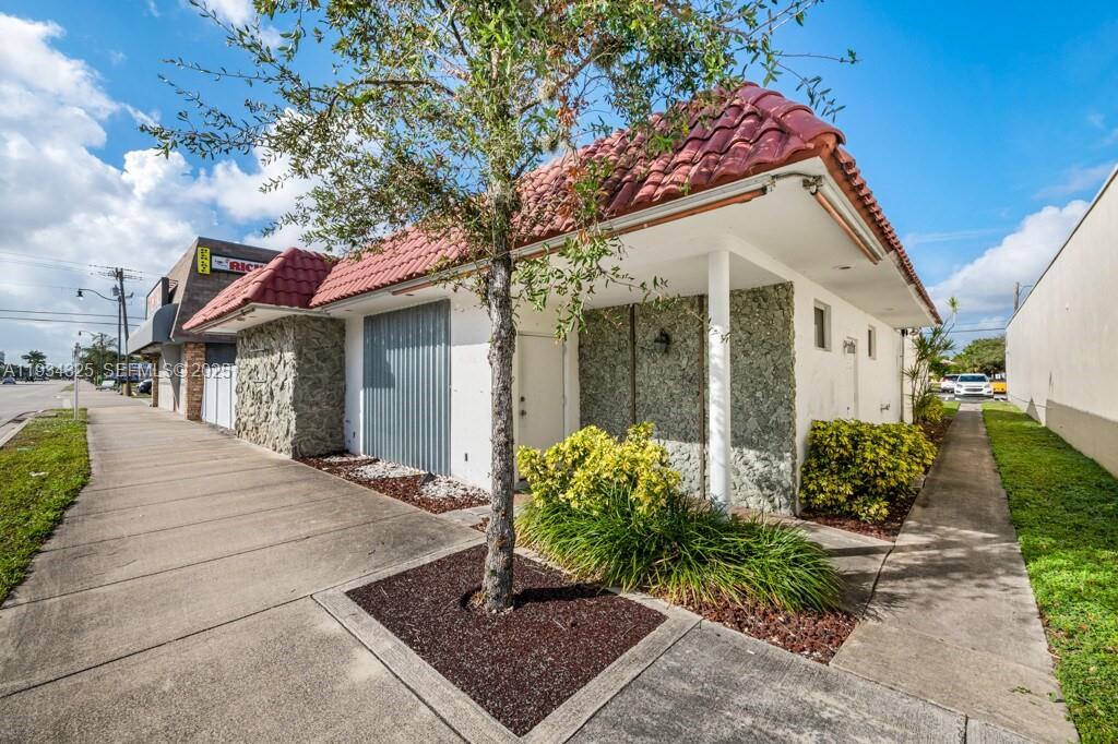 A single-story commercial building with a red tile roof and stone facade exterior — 4749 Hollywood Blvd, Hollywood FL 33021, HOLLYWOOD, FL