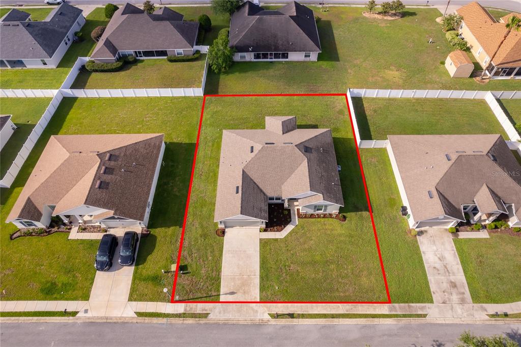 An aerial view shows a single-family house with a gray roof on a residential lot — 226 NW 44TH STREET, OCALA, FL