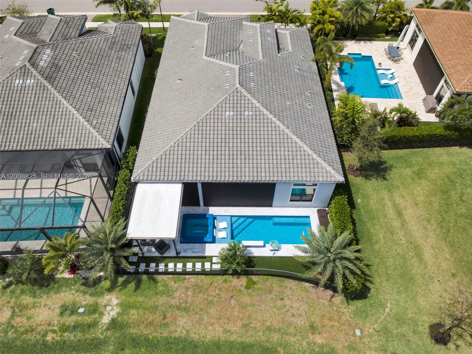 An aerial view shows a house with a tiled roof, a private pool, and landscaping — 8022 Deer Lake Ct, Parkland FL 33067, PARKLAND, FL