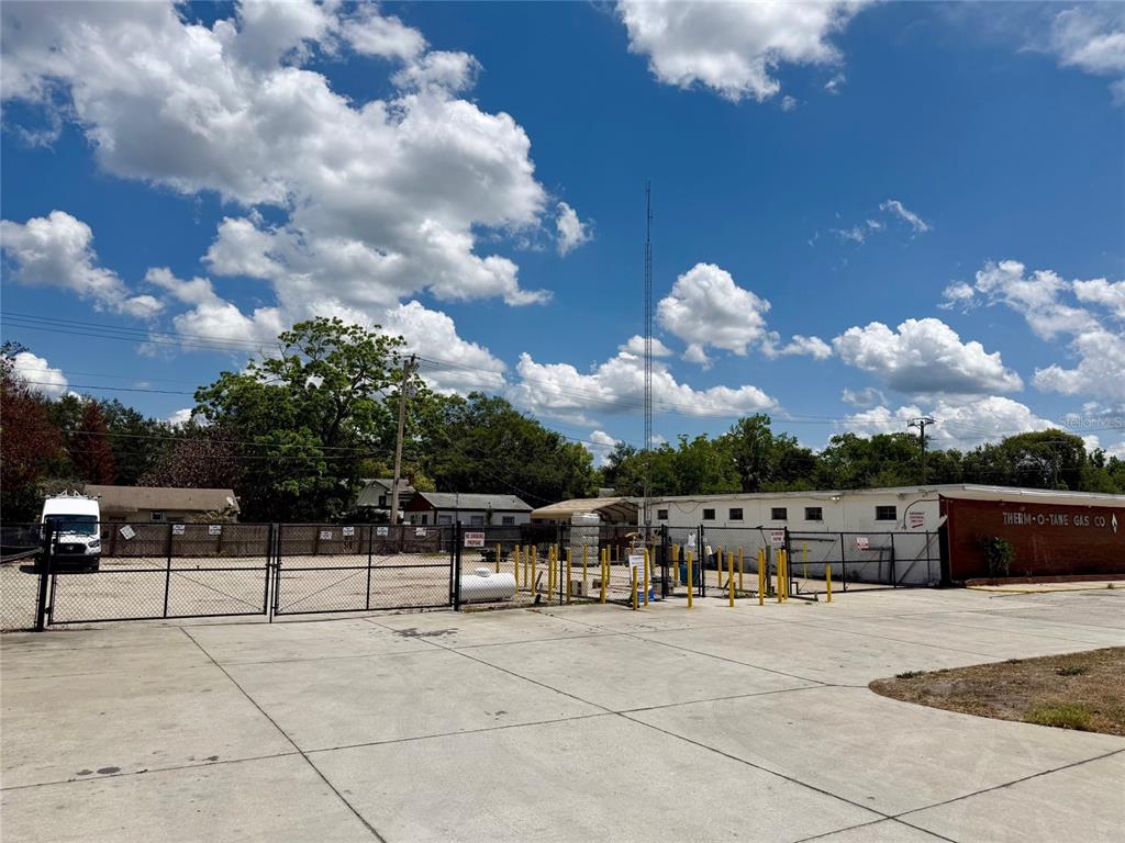 A fenced commercial lot features a concrete parking area and a Therm-O-Tane Gas Co. building — 414 W 9TH STREET, SANFORD, FL