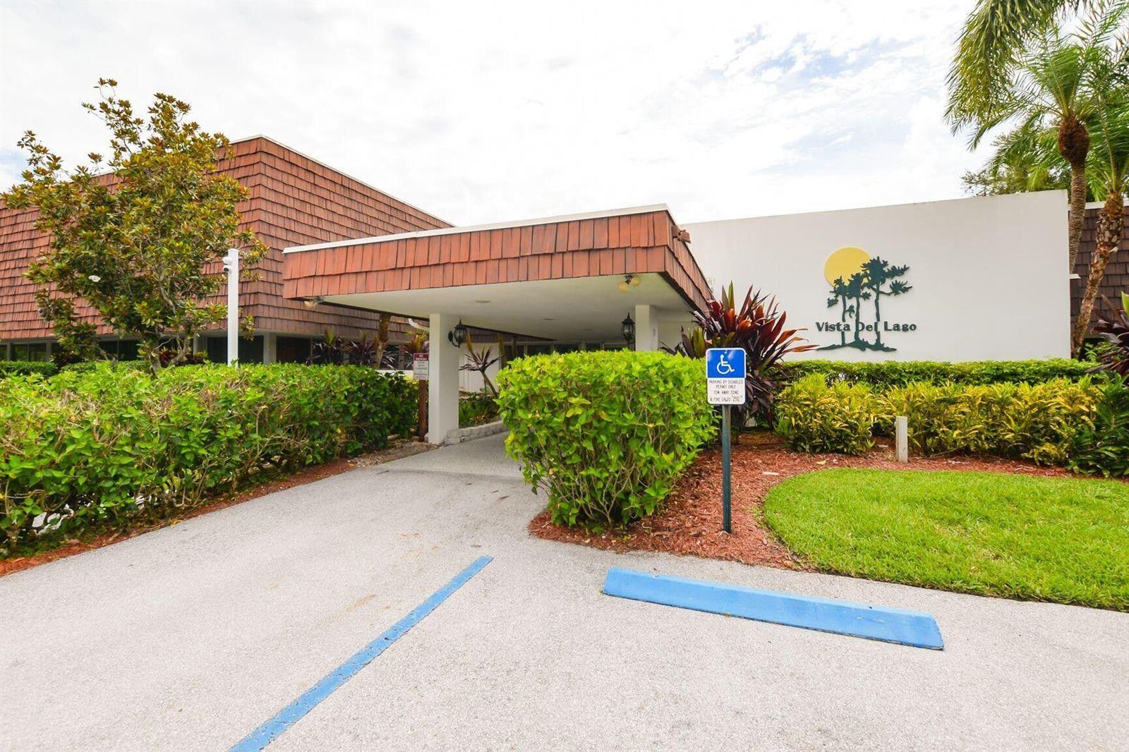 The exterior of a building features a covered entrance, a handicap parking sign, and landscaping — 1225 NW 21st Street # 311, Stuart FL 34994, STUART, FL