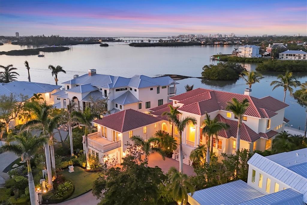 An aerial view of a large waterfront estate with multiple buildings, palm trees, and pools — 1137 N LAKE SHORE DRIVE, SARASOTA, FL
